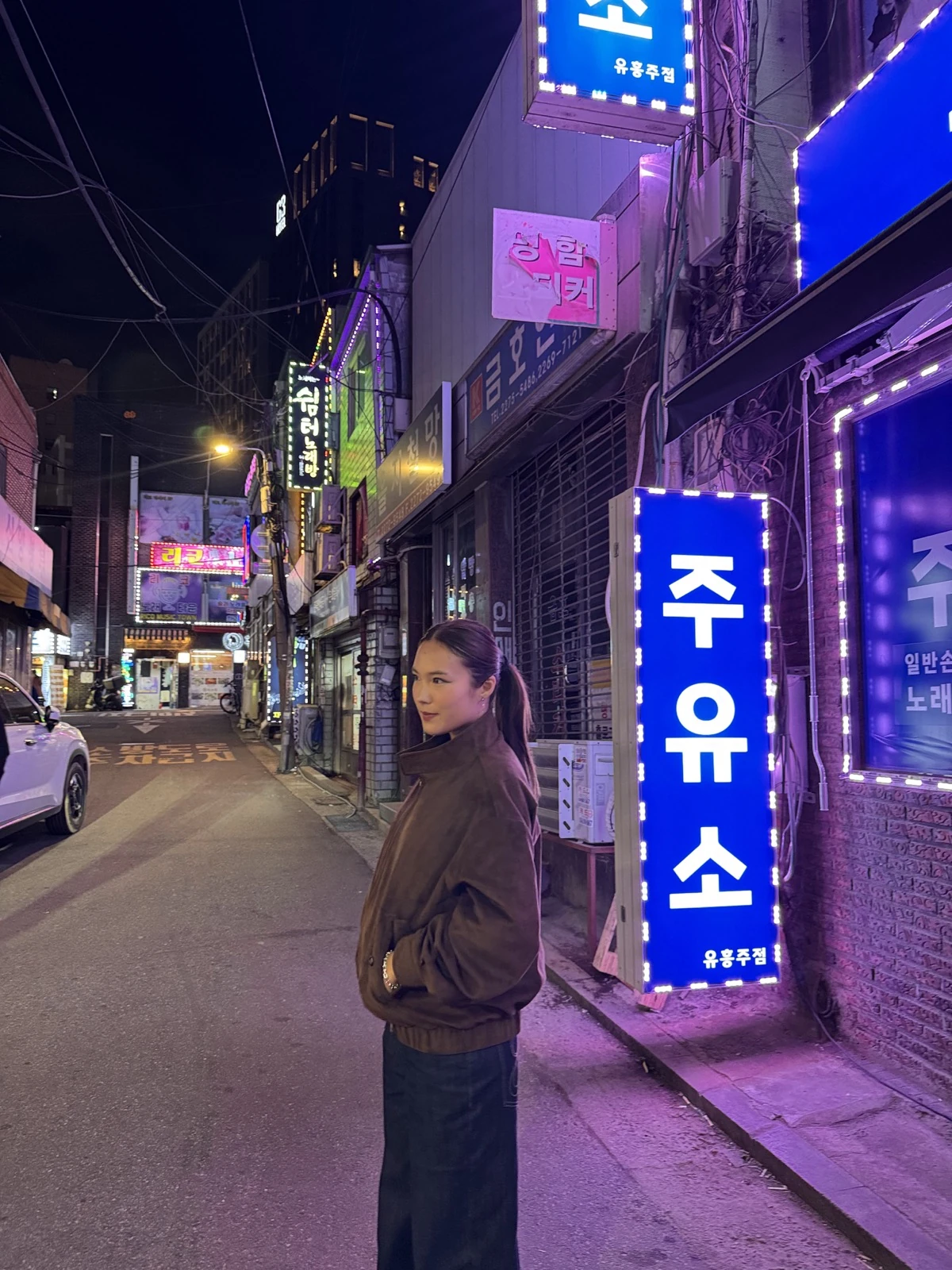 Ubin standing in a city street at night.