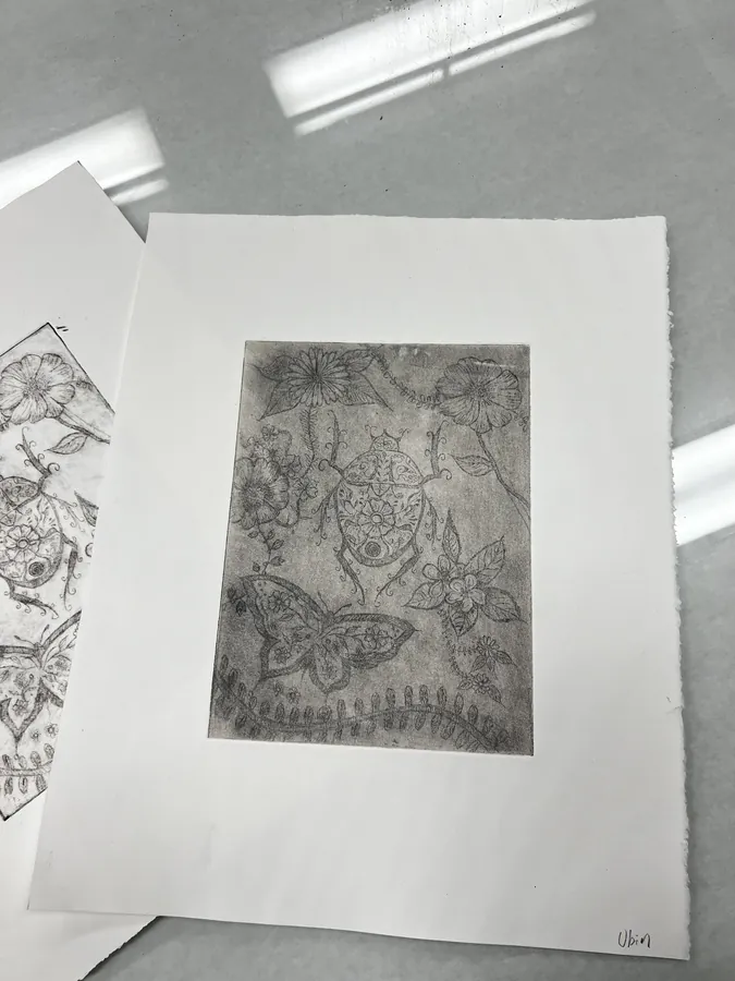 An intaglio print of flowers, a butterfly and a beetle, inked in grey on cream paper.