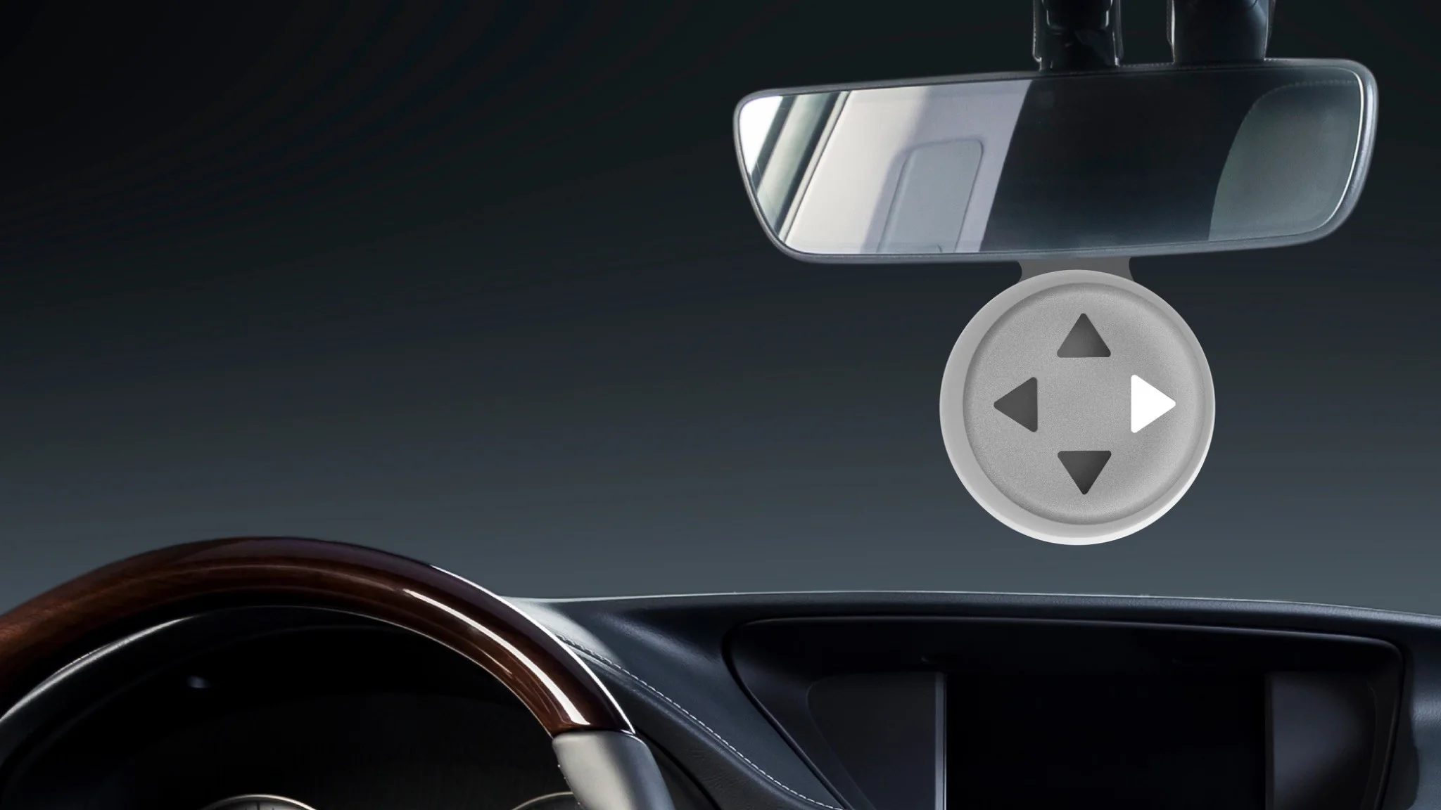 The DirecTone device hanging from a car's rear-view mirror at night, its four arrows visible against a dark interior.