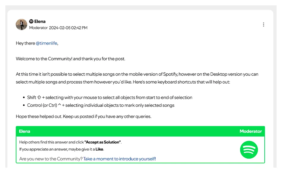 A Spotify Community reply from a moderator explaining that selecting multiple songs is not possible on mobile and listing the desktop keyboard shortcuts.